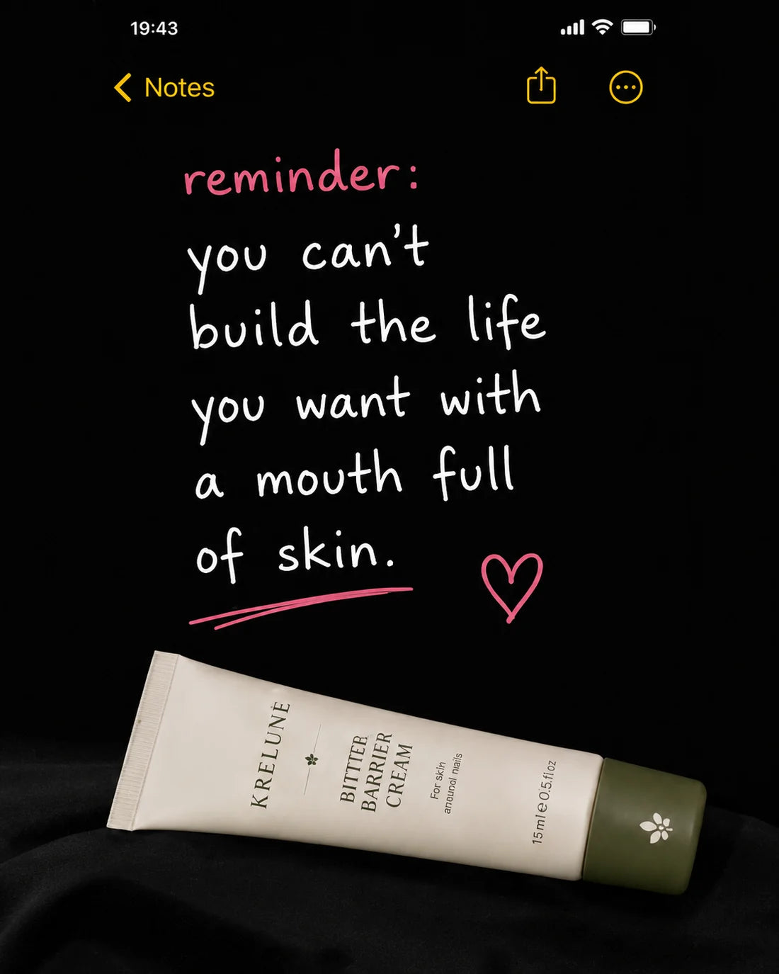 A phone note that reads: reminder — you can't build the life you want with a mouth full of skin. The Krelune Bitter Barrier Cream lies beside it.